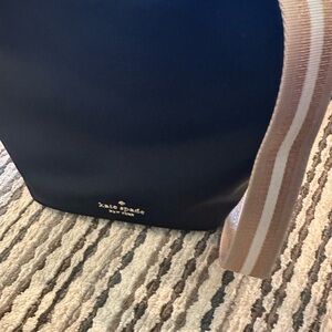 kate spade black crossbody bag with striped beige strap